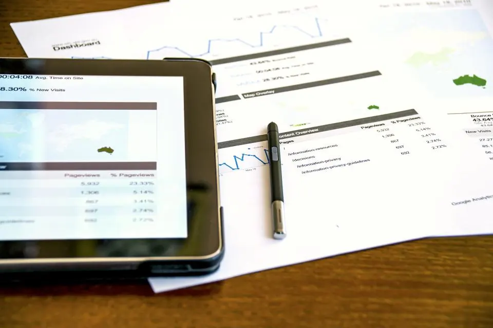 Printed reports and a tablet showing business figures