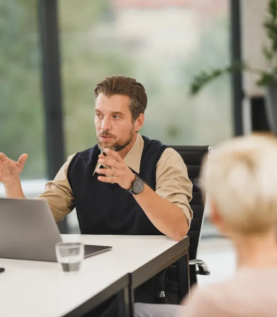 Business meeting around a table with a laptop